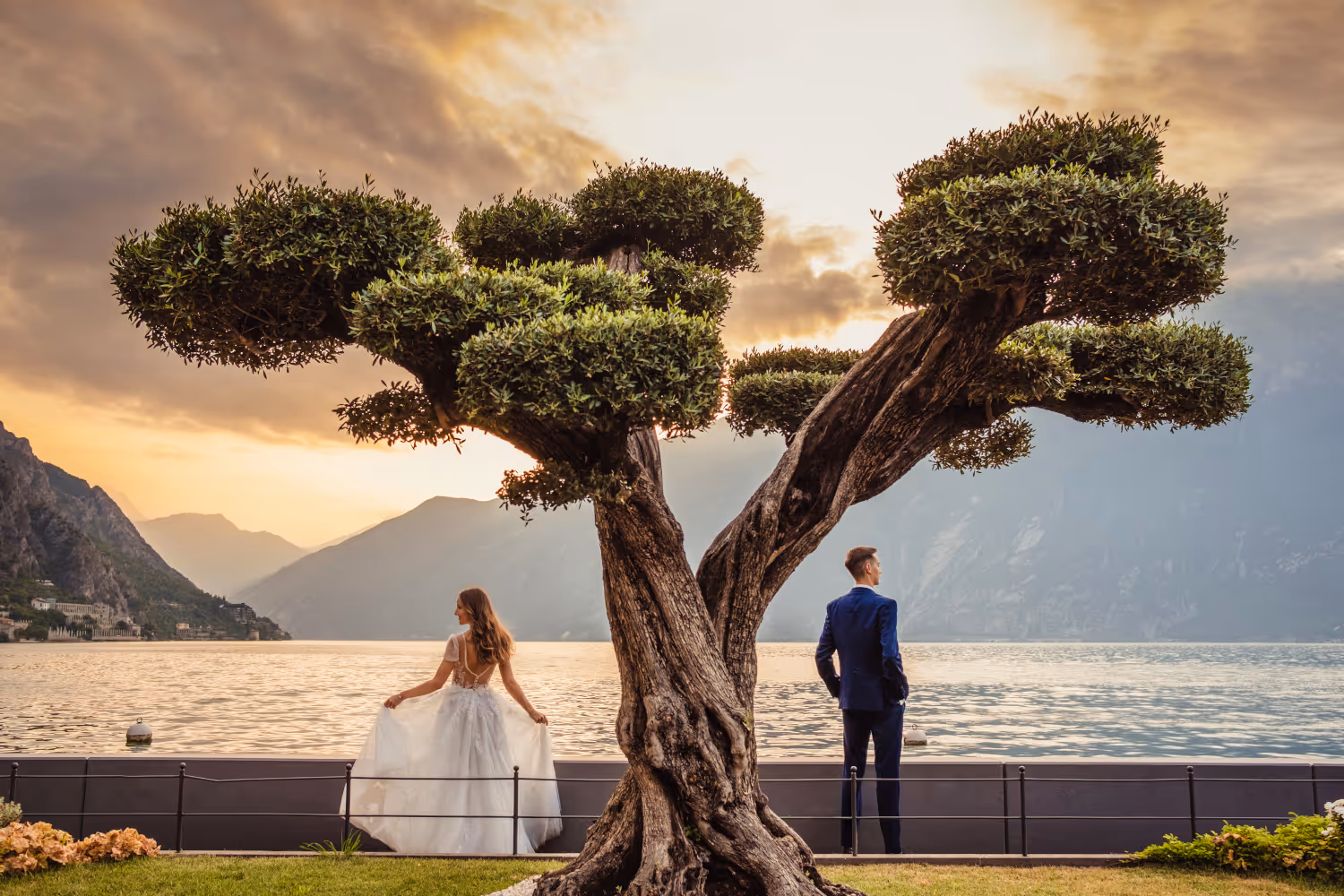 Wedding in Italy. Lake Garda. Limone Sul Garda. Young couple standing next to each other in a beautiful shot of Lake Garda.