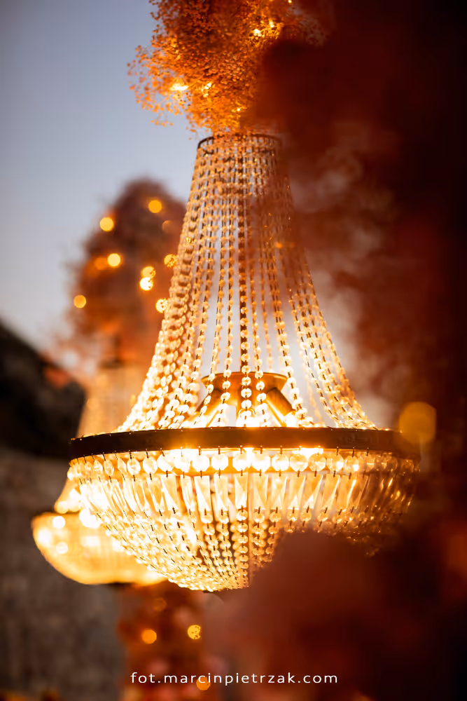 Wedding in Greece, Santorini. View of a lantern illuminating the guest table.